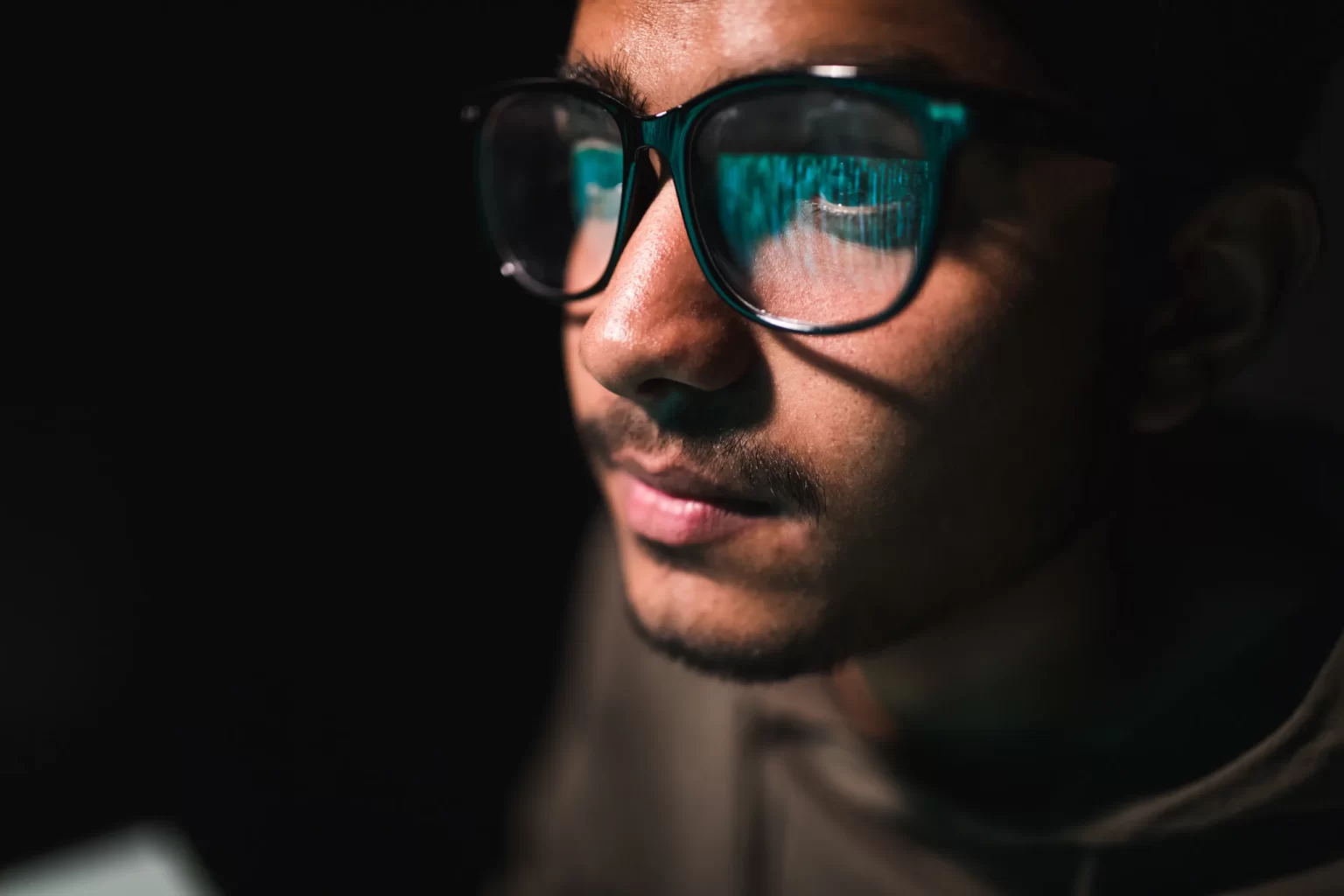 Code informatique se reflétant dans des lunettes